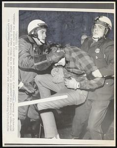 Montreal: Montreal Riot Squad Officers carry away demonstrators to paddy-wagon following the occupation of buildings on the McGill campus by French University of Montreal students early 12/4. Police moved quickly and ejected the students.