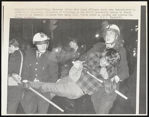 Montreal: Montreal Police Riot Squad Officers carry away demonstrator to paddy-wagon following the occupation of buildings on the McGill campus by French University of Montreal students early 12/4. Police moved quickly and ejected the students.
