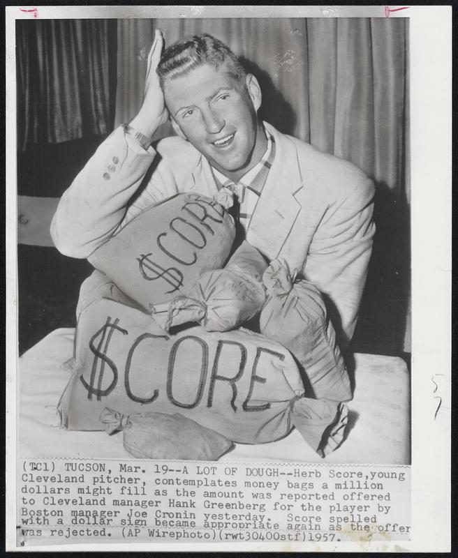 A Lot of Dough--Herb Score, young Cleveland pitcher, contemplates money bags a million dollars might fill as the amount was reported offered to Cleveland manager Hank Greenberg for the player by Boston manager Joe Cronin yesterday. Score spelled with a dollar sign became appropriate again as the offer was rejected.