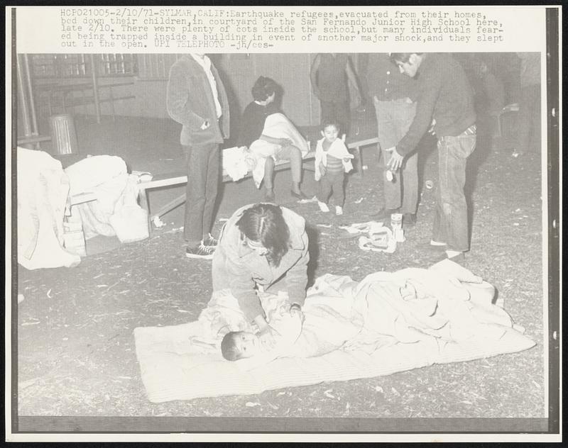 Earthquake refugees, evacuated from their homes, bed down their children, in courtyard of the San Fernando Junior High School here, late 2/10. There were plenty of cots inside the school, but many individuals feared being trapped inside a building in event of another major shock, and they slept out in the open.