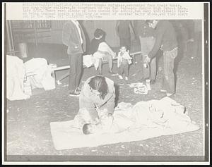 Earthquake refugees, evacuated from their homes, bed down their children, in courtyard of the San Fernando Junior High School here, late 2/10. There were plenty of cots inside the school, but many individuals feared being trapped inside a building in event of another major shock, and they slept out in the open.