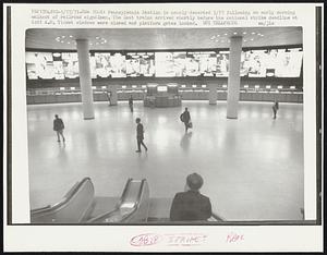 Pennsylvania Station is nearly deserted 5/17 following an early morning walkout of railroad signalmen. The last train arrived shortly before the national strike deadline at 6:01 A.M. Ticket windows were closed and platform gates locked.