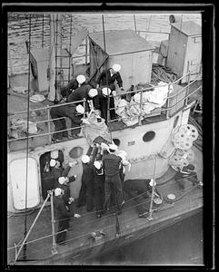 Body of Major Yoshio Inouye, Japanese consulate at Buenos Aires, is lowered over side of the destroyer Shaw