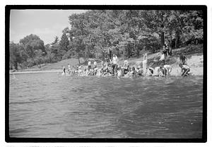 Boys sending out model sailboats