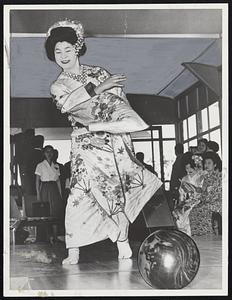 Honorable Strike is uncorked by lovely Ichi Matsu at the opening of a ten-pin bowling pavilion at the recent Tokyo International Fair.