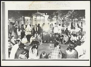 White House Vigil--A crowd gathers on the Pennsylvania Avenue sidewalk in front of the White House tonight shortly before President Nixon's news conference in the East room.