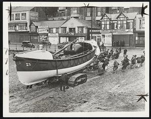 Lifeboat Heroes Left Money by Female Admirer The members of the crew of the Scarborough lifeboat "Herbert Joy", who recently were willed $1,500 between them by a lady who witnessed one of their sea rescues, are pictured hauling their boat ashore after a rescue trip recently to the keel boat "Hyperion", which was endangered by heavy seas. The Hyperion successfully made port.