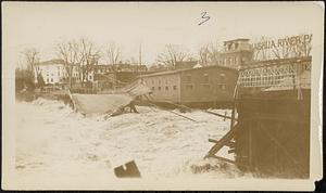 Main St. bridge being swept away by flood waters