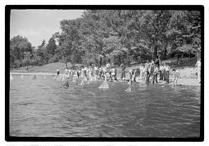 Boys sending out model sailboats