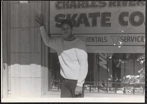 Young man standing in front of a Skate Co. storefront