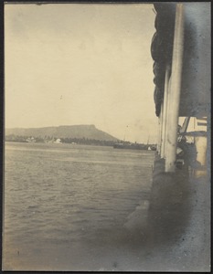 View of harbor from dock or boat, mountain in distance