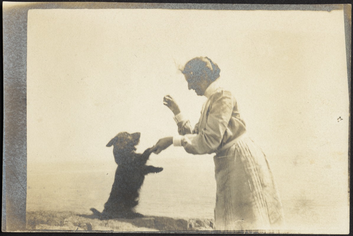 Helen Stevens Coolidge playing with dog (possibly "Ping")