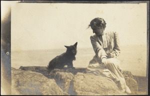 Helen Stevens Coolidge sitting with dog (possibly "Ping") at beach