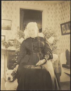 Harriet M. Cornwall Granger (Mrs. George Granger) seated in chair with dog