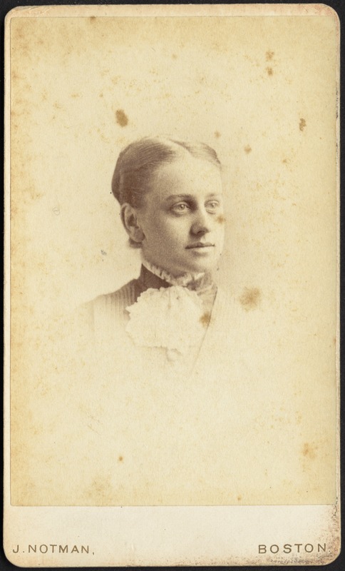 Young woman wearing high collar with white ruffle