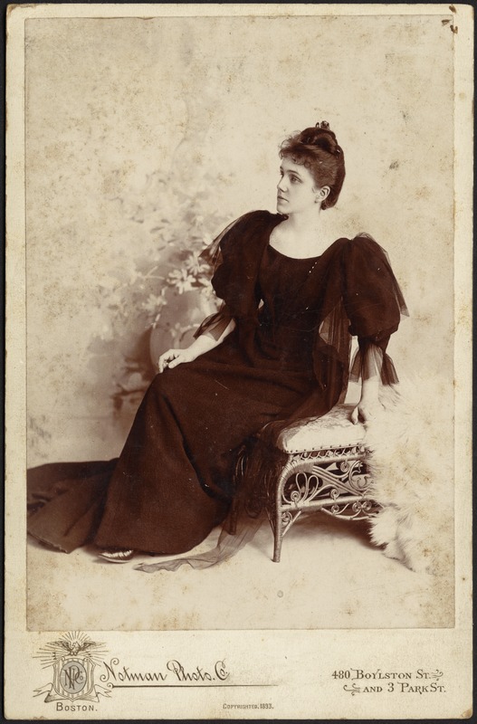 Mary "Mollie" Stevens in dark dress, seated