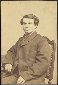 Edward Myron Stevens seated in chair