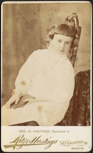 Young child sitting in chair with book