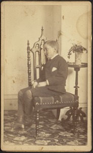 Charles Harwood Brown seated sideways in chair