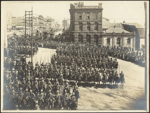 Mounted British soldiers in formation in city square near Council Chamber