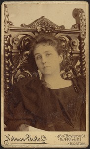 Mary "Mollie" Stevens in dark dress seated in carved wooden chair