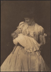 Woman in white dress holding infant