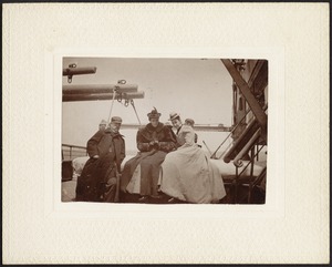 Four people on deck of ship