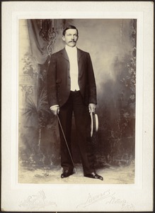 Studio portrait of Vice Consul John Gardner Coolidge with straw hat and crop