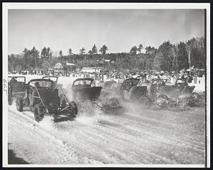 Jalopies Off In A Cloud Of Ice -- Jalopy racing on ice was one of the features of the 24th annual Winter Carnival of the Jaffrey, N.H. Outing Club which closed yesterday. Some fifteen jalopies in the senior division are shown throwing up snow and ice in a fast start on the 20-inch thick Lake Contoocook.