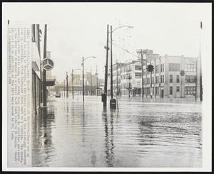 No Business on Broadway--There was no business on part of Broadway, a few blocks east of the principal downtown area in Louisville, after Beargrass Creek went on a rampage. The creek, normally about ankle deep, was among many streams to overflow yesterday as the city was drenched by a record 6.98 inch rain in 24 hours. About 100 cars in an auto firm at the left were moved to dry land.