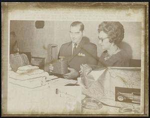 Leo A. Boyd, L, and his wife admire a musical decanter filled with [illegible] that was given to him in honor of his first anniversary marking one year of life with the heart of a Mexican woman beating in his chest. His "birthday" party was held in the special transplant unit of St. Lukes hospital in Houston.