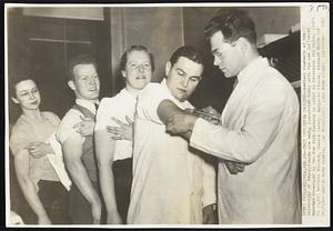 Test Influenza Vaccine--Medical students at the University of Pennsylvania are being inoculated today with the new influenza vaccine developed by two New York doctors in order to determine its value. (left to right) Barbara Winters, Horace Lavely, Margaret Storrs, Richard White and Dr. Tance Harris with needle.