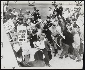 Pickets and Police Clash in Hollywood Strike- When police tried to escort non-striking workers through the main gate at the Warner Bros, studio in Burbank, pickets clashed with them.