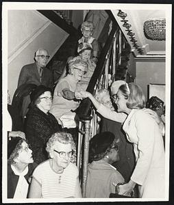 Statler Hotel Mrs. White greets some of Old timers seated on stairs of full house crowd at Mass Legislative Council for Older Americans