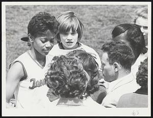 Fitness Form displayed by professional football star Johnny Unitas of the Baltimore Colts over the weekend at B. U. Field is shown in the top photo. Below, triple Olympic winner Wilma Rudolph gives tips to a group of budding athletes and admirers after her sprint exhibition.