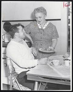 Home Cooking is served up to Lowell's lightheavyweight sensation, Billy Ryan, by his mother, Mrs. Mary Ryan. Billy is training for a return bout with Joe Tomasello Tuesday at Mechanics Hall.