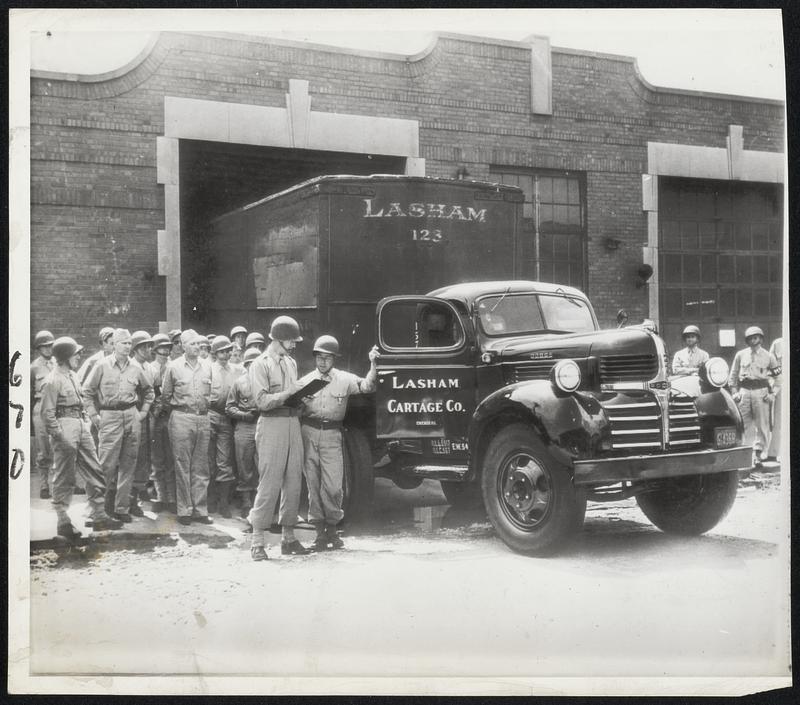 Ready for Trucks - A group of soldiers in Chicago, among those assigned to take out trucks during the truck strike. S/Sgt. John H. McComb (right) at the head of the line, is receiving instructions from Lt. Louis A. Alfier.