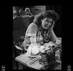 Unidentified woman at kitchen table