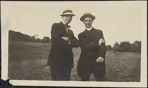 Clergyman and another man in a field