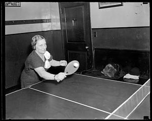 A woman playing ping pong