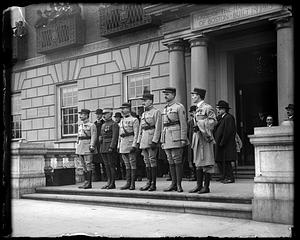 A group of men in military uniform standing in front of the Harvard Club, Boston