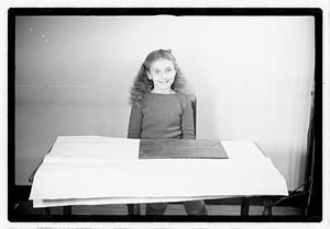 A girl matching fitting shapes in a puzzle