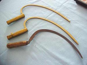 Two painted hardwood sickles