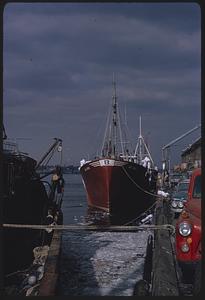 End view at pier of red boat labeled "Bay State," Boston