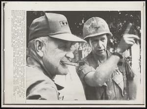 Explains Tactics-- Gen. Creighton W. Abrams, commander of U.S. Forces in Vietnam, chews on his cigar as Col. George Patton, son of the famed World War II general, explains tactics used to secure a village 25 miles north of Saigon. Patton's 11th Armored Regiment sealed off the village of Chan Luu while Vietnamese troops flushed out Viet Cong guerrillas.