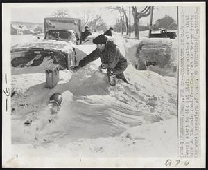 Plymouth, Mass. - Stormbound on Cape Road - Owners start to dig out their cars stalled all night here on the main road from Cape Cod to Boston during the worst snowstorm of years.