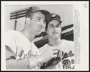 The starting pitchers for the third game of the World Series 10/8, Los Angeles Dodgers Claude Osteen (L) and Baltimore Orioles Wally Bunker, compare grips at Memorial Stadium,10/7.