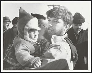 Son in law of Howard Marsten, Fred Jelmberg of Rockport, wife, son Jannik 1 year at protest demonstration in front of Army Base