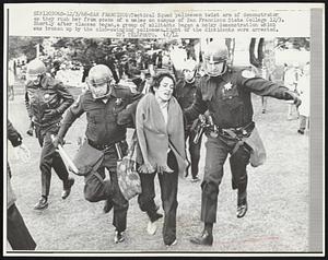 Tactical Squad policemen twist arm of demonstrator as they rush her from scene of a melee on campus of San Francisco State College 12/3. Shortly after classes began, a group of militants began a noisy demonstration which was broken up by the club-swinging policemen. Eight of the dissidents were arrested.