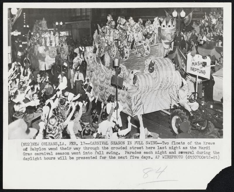 Carnival Season in Full Swing--Two floats of the Krewe of Babylon wend their way through the crowded street here last night as the Mardi Gras carnival season went into full swing. Parades each night and several during the daylight hours will be presented for the next five days.